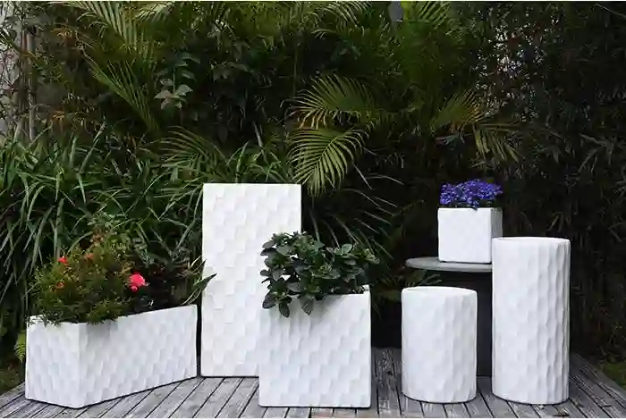 different sizes of concrete plant boxes and tall plant pots